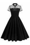 Højhalset sort prikket A Line 1950'er kjole