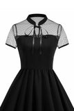 Højhalset sort prikket A Line 1950'er kjole