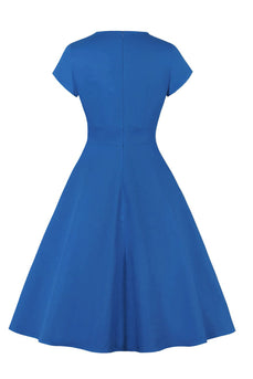 Juvelblå kjole fra 1950'erne med nøglehul