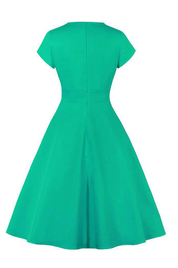 Juvelblå kjole fra 1950'erne med nøglehul